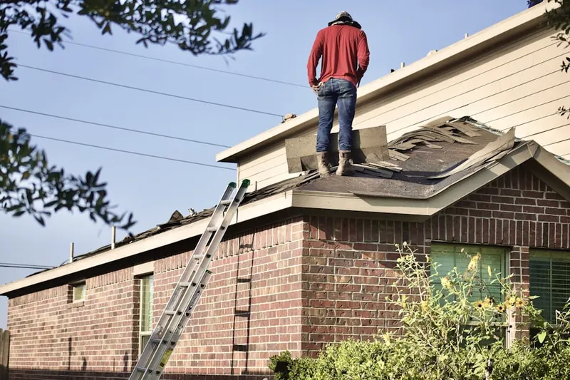 Professional roofer working on a residential roof in Moss Bay